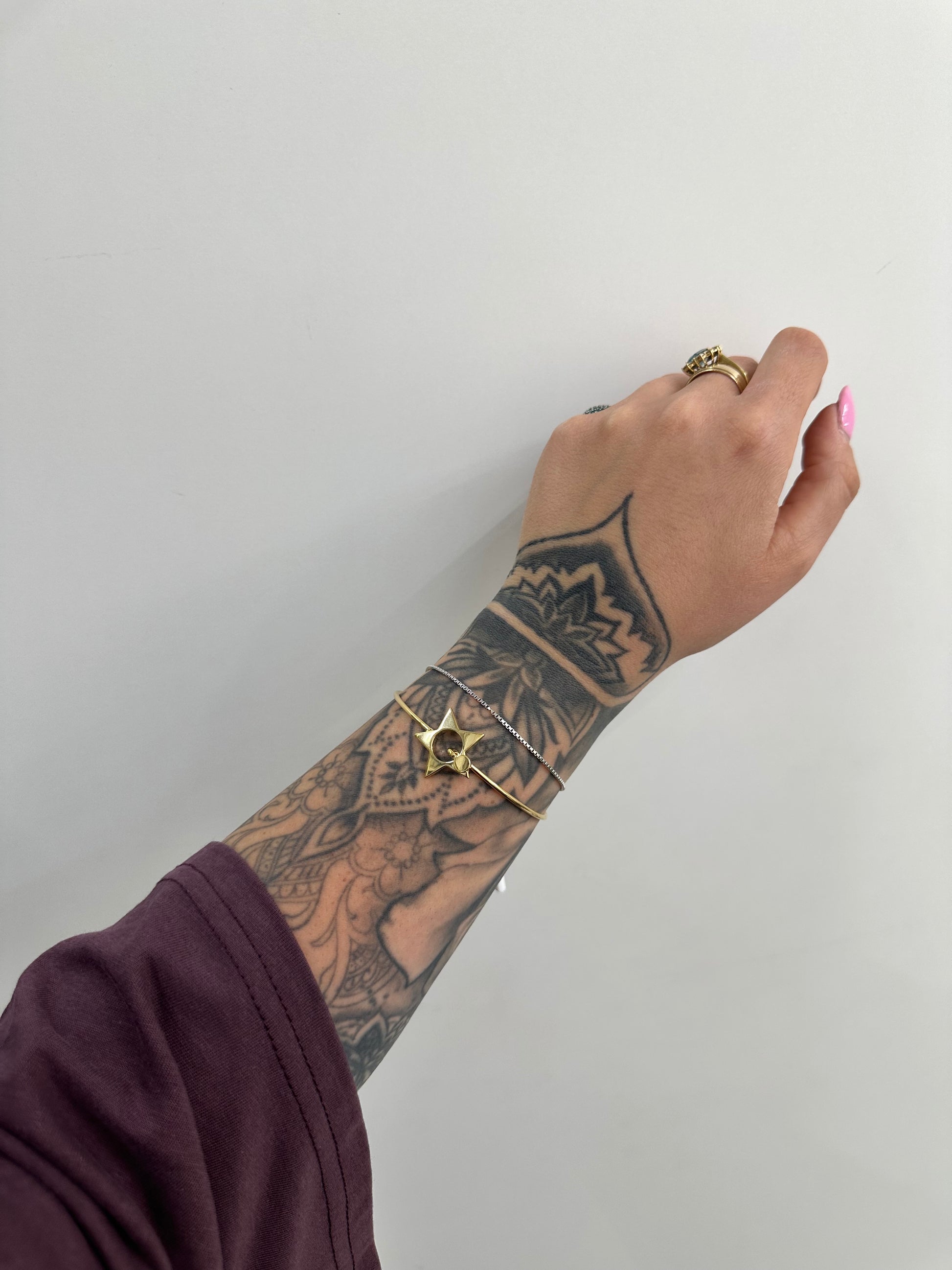 BRACCIALE RIGIDO CON STELLA ACCIAIO